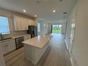 Modern kitchen with stainless appliances and a large island perfect for entertaining at 2333 Daisy Tree Rd, St Cloud, FL 34771