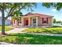 Charming single-Gathering home with red shutters and a matching red front door and a landscaped front yard at 3174 Grasmere View Pkwy, Kissimmee, FL 34746