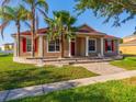 Charming single-Gathering home with red shutters and a matching red front door and a landscaped front yard at 3174 Grasmere View Pkwy, Kissimmee, FL 34746
