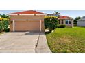 A single Gathering home with a two car garage, solar panels, and a well maintained lawn at 3174 Grasmere View Pkwy, Kissimmee, FL 34746