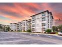 Wide view of the condo complex with ample parking under a stunning sky at 4013 Breakview Dr # A407, Orlando, FL 32819