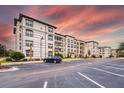 Condominium complex exterior with ample parking, mature trees, and landscaping at 4013 Breakview Dr # A407, Orlando, FL 32819