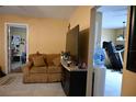 Cozy living area with couch and large screen tv with doorways leading to other rooms at 410 5Th S St, Dundee, FL 33838