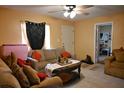 Comfortable living room featuring a ceiling fan, neutral color scheme and ample seating at 410 5Th S St, Dundee, FL 33838