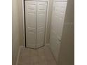 Tiled hallway featuring a closet and white interior doors at 417 Southern Pecan Cir # 201, Winter Garden, FL 34787