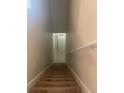 Carpeted stairway leading to upper floors and a closet, featuring a handrail and neutral wall paint at 417 Southern Pecan Cir # 201, Winter Garden, FL 34787