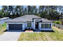 Charming single Gathering home boasting a well maintained lawn and landscaped front yard with a paved driveway at 5110 Sw 158Th St, Ocala, FL 34473
