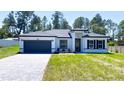 Inviting curb appeal in this single Gathering home with black trim and a paved driveway and landscaped front yard at 5110 Sw 158Th St, Ocala, FL 34473