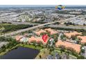 Community aerial view with multiple buildings, beautiful landscaping, and proximity to main roads and Universal Studios at 5447 Vineland Rd # 1308, Orlando, FL 32811