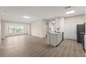 Bright living space with hardwood floors and lots of natural light, leading into an open kitchen concept at 5447 Vineland Rd # 1308, Orlando, FL 32811