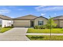 Inviting single-Gathering home with a manicured lawn and an attached two-car garage at 5857 Beefmaster Rd, St Cloud, FL 34771