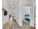 Bright hallway featuring wood flooring and a view into a living room and a bedroom at 5857 Beefmaster Rd, St Cloud, FL 34771