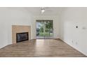 Bright living room boasts hardwood floors, fireplace, and sliding glass doors to the outside at 6088 Westgate Dr # 201, Orlando, FL 32835