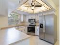 Bright kitchen featuring stainless steel appliances, ample countertop space, and white cabinetry at 622 N Goodrich Dr, Deltona, FL 32725
