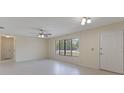 Spacious living room with neutral walls, ceiling fan, and large window at 622 N Goodrich Dr, Deltona, FL 32725