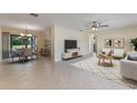 Open-concept living and dining area with tile flooring, neutral walls, and an abundance of natural light at 622 N Goodrich Dr, Deltona, FL 32725