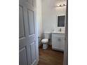 Bright half bathroom featuring vinyl floors, a toilet and modern vanity with storage at 6741 Heavitree Dr, Sebring, FL 33876