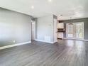 Bright living room with grey walls, white trim, light wood-look floors and view into the kitchen at 8228 Shriver Dr, Orlando, FL 32822