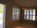 The dining room features plantation shutters and an elegant hanging light fixture at 8532 Bay Springs Dr, Orlando, FL 32819