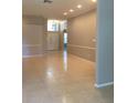 Spacious living room with tile floors and a soaring ceiling with transom window at 8532 Bay Springs Dr, Orlando, FL 32819