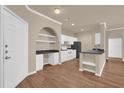 Clean kitchen with black appliances, white cabinets, lots of counter space, and durable wooden floors at 860 N Orange Ave # 306, Orlando, FL 32801