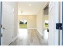 View of the home's foyer and living space, with wood-look floors and an open floor plan at 8600 Castile Rd, Sebring, FL 33876