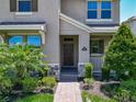 Inviting front entrance with manicured landscaping and stone accents at 9971 Beach Port Dr, Winter Garden, FL 34787