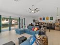 Spacious living room with natural light, ceiling fan, and a comfortable sectional sofa, perfect for relaxation at 1064 Universal Rest Pl, Kissimmee, FL 34744