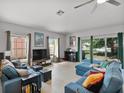 Bright living room featuring comfortable seating, large windows, and an entertainment center, ideal for gatherings at 1064 Universal Rest Pl, Kissimmee, FL 34744