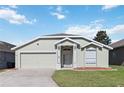 Lovely one-story home featuring a well-kept lawn and a convenient two-car garage at 1111 High Vista Dr, Davenport, FL 33837