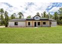 Beautiful single-story home featuring a modern farmhouse design and inviting front porch with wood columns at 12193 Sw 69 Pl, Ocala, FL 34481