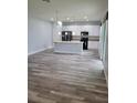 Spacious kitchen with stainless steel appliances, a center island, and white cabinetry at 12845 Sawgrass Pine Cir, Orlando, FL 32824