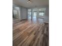 Open-concept living area with modern wood-look flooring and lots of natural light at 12845 Sawgrass Pine Cir, Orlando, FL 32824