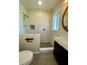 Updated bathroom featuring a walk-in shower with gray pebble floor and modern vanity at 1326 Edmundshire Ln, Orlando, FL 32806