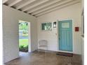 Charming covered front porch with painted brick and a modern blue front door at 1326 Edmundshire Ln, Orlando, FL 32806