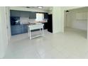 Open kitchen area with dark cabinets, an oven, and a tile floor at 1326 Edmundshire Ln, Orlando, FL 32806