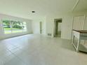 Bright living room featuring tile flooring, a large window, and a built-in shelf at 1326 Edmundshire Ln, Orlando, FL 32806