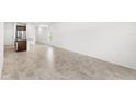 Open-concept living space with tile flooring flowing into a kitchen featuring a central island at 1396 Mirabella Cir, Davenport, FL 33897