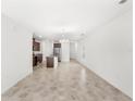 Open-concept living space with tile flooring flowing into a kitchen featuring a central island at 1396 Mirabella Cir, Davenport, FL 33897