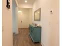 Inviting entryway showcasing wood-look floors, a stylish accent table, and a mirror that brightens the space at 14955 Lebeau Loop, Winter Garden, FL 34787