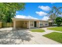 Well-maintained single-story home featuring a covered carport and green lawn at 1531 Huntington St, Lakeland, FL 33801