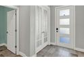 Inviting entryway with tile floors, featuring a stylish front door and elegant French doors at 15975 Marina Bay Dr, Winter Garden, FL 34787