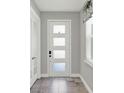 Bright entryway showcases a frosted glass front door, tile floors and adjacent French doors at 15975 Marina Bay Dr, Winter Garden, FL 34787