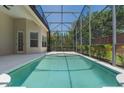 The backyard features a screened in pool and a private setting with green foliage at 1638 Whitney Isles Dr, Windermere, FL 34786
