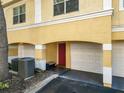 Two-story condo with a garage and a red front door at 1810 Shadow View Cir # 1810, Maitland, FL 32751
