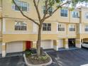 Two-story condo with a garage and a red front door at 1810 Shadow View Cir # 1810, Maitland, FL 32751