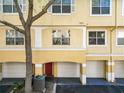 Two-story condo with a garage and a red front door at 1810 Shadow View Cir # 1810, Maitland, FL 32751