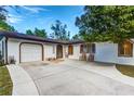 Welcoming single-story home boasts a brick-accented facade and a convenient attached garage at 205 Elaine Pl, Chuluota, FL 32766