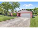 The home has an attached two-car garage and long driveway for extra parking at 2409 Pinyon Ct, Kissimmee, FL 34746