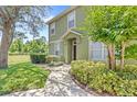 Inviting walkway leading to the front door, surrounded by lush greenery and landscaping at 2430 Little Gem Loop, Sanford, FL 32773